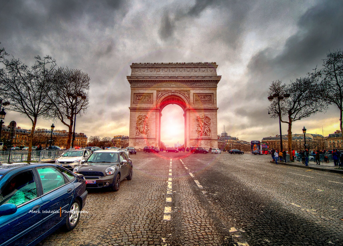 Vast Grand Canyon with rugged layered rock formations under a moody cloudy sky.